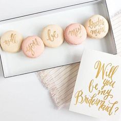 macaroons in a box with gold lettering on the top and one is for bridesmaids