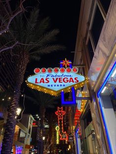 the las vegas sign is lit up at night