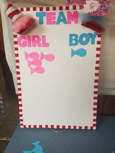 a sign that says team girl boy on the side of a table with decorations around it