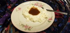 a plate with mashed potatoes and gravy on it