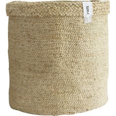 a large round basket with a white label on the front and bottom, in natural jute