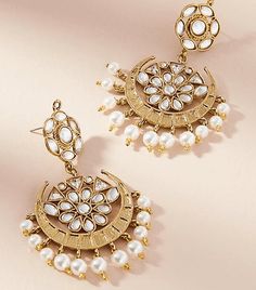 Love India by Blossom Box's Starburst Pearly Earrings comes in a gold plated finish with stunning polki stones & pearls to make these exquisite earrings really special - this pair are light in weight & can be paired with almost any outfit. Perfect accessory for every jewelry box! Handcrafted Metal: Metal Alloy, Gold Plated Stone: Polki Stones & Pearls Size: Length: 2.5" Width: 2.75" Closure: Post for Pieced Ears Affordable Traditional Festive Earrings, Luxury Pearl Earrings For Diwali Gift, Luxury Round Earrings For Diwali, Luxury Traditional Pearl Earrings For Festivals, Luxury Pearl Earrings With Intricate Design For Diwali, Luxury Festive Meenakari Pearl Earrings, Pearl Size, Jewelry Box, Pear