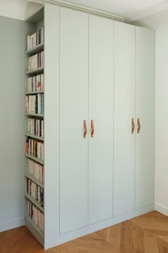 an image of a room with bookshelves and cabinets on the wall in it