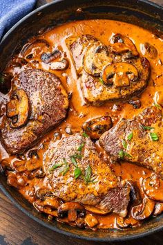 a skillet filled with meat covered in mushroom gravy