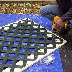 a man is using a drill to cut out the top of a piece of plastic