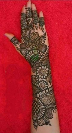 the hand is decorated with henna on it