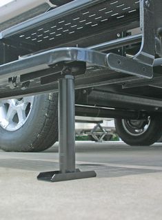 the back end of a truck with metal bars on it's sides and wheels