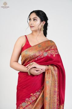 Maroon Kani Floral Pallu Silk Saree, a vintage craft saree, is an exquisite creation crafted from premium silk fabric, accentuated with intricate Kani weaving throughout the borders and pallu. This saree features beautiful traditional and floral motifs in rich hues, enhanced by a stunning color palette. A touch of zari thread adds a subtle shine, further enhancing the intricate motifs and giving the saree a regal appearance. It is accompanied by a contrasting blouse piece with Kani Jamawar weaving, perfectly complementing the overall design. The design inspiration for this Pashmina Silk saree is drawn from the heritage weaves of ancient Pashmina shawls from Kashmir, dating back to the Mughal era. The motifs are also inspired by nature, reflecting the timeless beauty of floral patterns. The Elegant Jamawar Pre-draped Saree For Wedding, Elegant Wedding Pre-draped Jamawar Saree, Banarasi Silk Traditional Wear With Unstitched Blouse For Wedding, Dola Silk Lehenga For Puja, Festival Jamawar Blouse Piece, Wedding Traditional Wear With Unstitched Banarasi Silk Blouse, Wedding Jamawar Blouse Piece For Festivals, Elegant Fitted Jamawar Saree, Wedding Festival Jamawar Blouse Piece