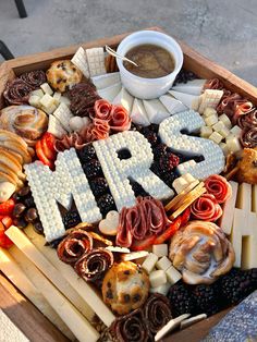 a platter with the word mr and mrs spelled out in letters surrounded by food