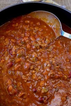 a pot filled with chili and beans on top of a table