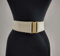 This wide women's belt cinches your waist to give you an hourglass figure. It's more comfortable than traditional non-stretchy women's belts and is super cute paired with a dress or loose tunic. Perfect for a classic addition to your current wardrobe. MEASUREMENTS: - width - 2.6" / 5.0 cm - minimum waist length in circumference - 31.4" / 80 cm - maximum waist length in circumference - 47.2" / 120 cm Color: cream, light beige, ivory Condition: excellent vintage Please note that the actual color o Timeless Formal Belts With Gold-tone Hardware, Elegant Beige Belt, Chic Fitted Beige Corset Belt, Vintage Formal Belt With Gold Buckle, Elegant Adjustable Beige Belt, Loose Tunic, Suspender Belt, Belts For Women, Suspenders