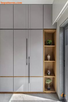 an image of a kitchen setting with cupboards and plants on the counter top area