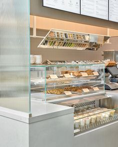 a display case in a bakery filled with lots of food