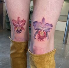 two tattoos on the legs of women with flowers