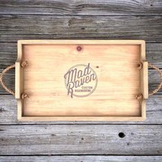 a wooden tray with the word mad river on it