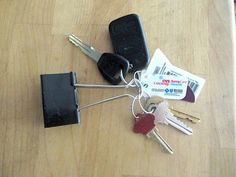 several keys are attached to the back of a car key holder on top of a wooden table