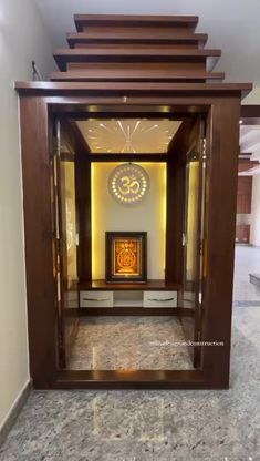 an open door with a clock on the wall behind it in a room that has marble floors and walls