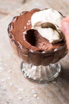 someone is scooping ice cream into a chocolate dessert