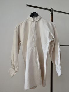 "C.1930s Hungarian linen shirt. Traditional folk clothing. Homespun linen. Opaque white glass buttons. Lovely simple cut.  Measures: 20 1/2\" underarm to underarm, 20 1/2\" across the shoulders, 9 1/2\" from shoulder to underarm, 20 1/2\" sleeves, 14\" collar, 28 1/2\" from top of the shoulder to hem. Great condition. Freshly laundered. The seams at the left underarm need some repair stitches as just a very small split here.  Feel free to ask any questions. Ships internationally via insured deli Vintage Linen Shirt With Relaxed Fit, Vintage Linen Shirt With Buttons, Vintage Linen Shirt With Button Closure, Classic Linen Blouse With Buttons, Linen Shirt With Button Cuffs For Daywear, Fitted Linen Blouse With Button Cuffs, Cream Linen Tops With Buttons, Beige Buttoned Shirt For Daywear, Cream Linen Top With Buttons