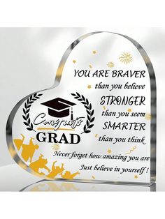 a glass heart shaped award with the words you are brave and an image of a graduation cap