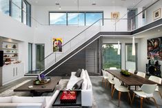 a living room filled with furniture next to a staircase