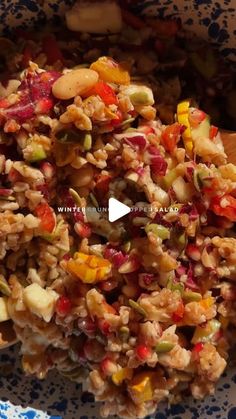 a bowl filled with rice and vegetables on top of a table