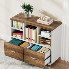 a book shelf with drawers and books on top