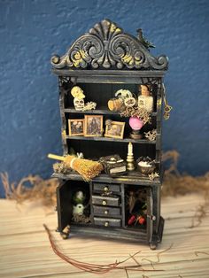 a miniature book shelf with pictures and other things on it