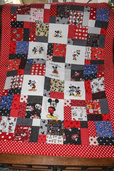 a quilt made to look like mickey and minnie mouses on red, white and black squares