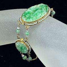 One Art Deco 14k Yellow Gold Jade Bracelet. There Are One Large Oval And Two Round Shaped Jade, Hand Carved Floral Pattern, Embellished With Natural Seed Pearls And Rope Link On The Bezel. The Jade Connet By Two Strands Of Natural Pearl And Jade Bead (5.0mm). The Oval Jade Is 35.0 X 20.0mm, The Round Jade Is 20.0mm Diameter. Total Weight 17.0gm, 7.0" Long, Hallmark 14k (1 Inch = 25.4 Mm; 1 Dime = 17.9mm). All Items Are Pre-Owned Unless Otherwise Stated. This Means They Have The Usual Aspects Of Pre-Owned Jewelry, Such As Light Scratches, Wear And Tarnish. Please Review All The Photos Which Will Be Part Of The Description. Formal Green Hand-strung Jewelry, Vintage Jade Jewelry Hand-strung, Vintage Hand-strung Jade Jewelry, Collectible Yellow Gold Jade Jewelry, Elegant Jade Jewelry For Collectors, Elegant Collectible Jade Jewelry, Jade Bead Bracelet, Jade Bracelet, Natural Pearl