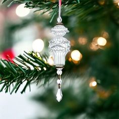 a glass ornament hanging from a christmas tree