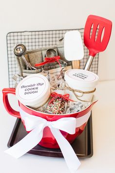 a red cup filled with lots of food and utensils on top of a tray