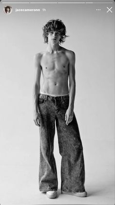 a shirtless young man is posing for a black and white photo with his hands in his pockets