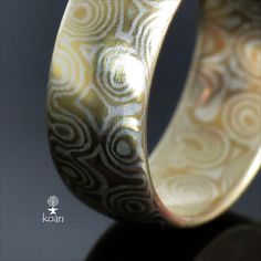 a close up of a ring on a black surface