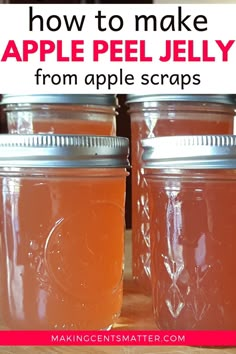 two jars filled with apple jelly sitting on top of a table