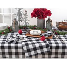 a black and white checkered table cloth with red poinsettis