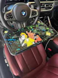 the interior of a car with an image of cartoon characters on it