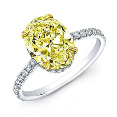 a yellow diamond ring with diamonds around it