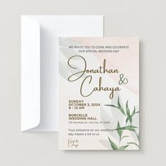 an elegant wedding card with greenery on the front and back, is displayed next to a white envelope