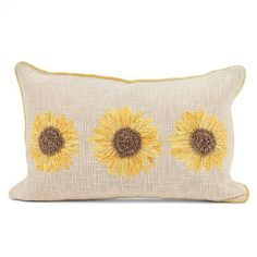 a yellow and brown pillow with three sunflowers on the front, two in the back