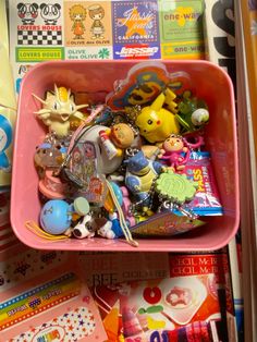 a pink bowl filled with lots of toys