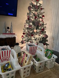 the christmas tree is decorated with red and white striped baskets, candy bars, and soda bottles