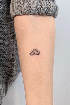 a woman's arm with a small mustache tattoo on the left side of her leg