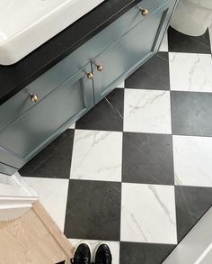 a black and white checkered floor in a bathroom