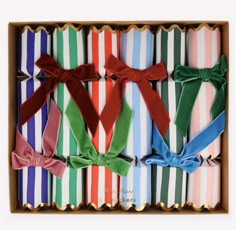 six different colored bow ties in a box