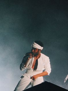 a man standing on top of a stage with a microphone