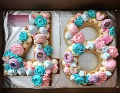 a cake in the shape of the number forty with flowers and seashells on it