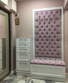 a room with some drawers and a pink bench in it's centerpieces