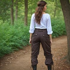 Set sail on a grand adventure with our Women Brown Pirate Pants, designed to evoke the rugged elegance of medieval and Viking eras. These trousers are meticulously crafted to offer both comfort and authenticity, making them perfect for renaissance fairs, LARP (Live Action Role Play) events, and fantasy cosplay. The rich brown fabric and high-waisted fit provide a flattering silhouette, while the durable construction ensures they withstand the rigors of any adventure, whether on land or at sea. Ideal for portraying a daring pirate, a noble Viking, or a humble peasant, these pants are a versatile addition to any costume collection. Embrace the spirit of the past with these Renaissance Larp Cosplay pants, which also seamlessly blend into steampunk and fantasy-themed outfits. The detailed craf Women Pirate Pants, Ren Faire Women Pants, Forest Themed Outfit, Ren Faire Pants, Pirate Academia, Viking Trousers, Fantasy Traveler Outfit, Fantasy Adventurer Outfit, Pirate Trousers