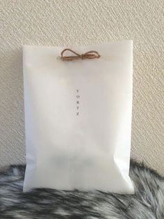 a white bag sitting on top of a fur covered floor